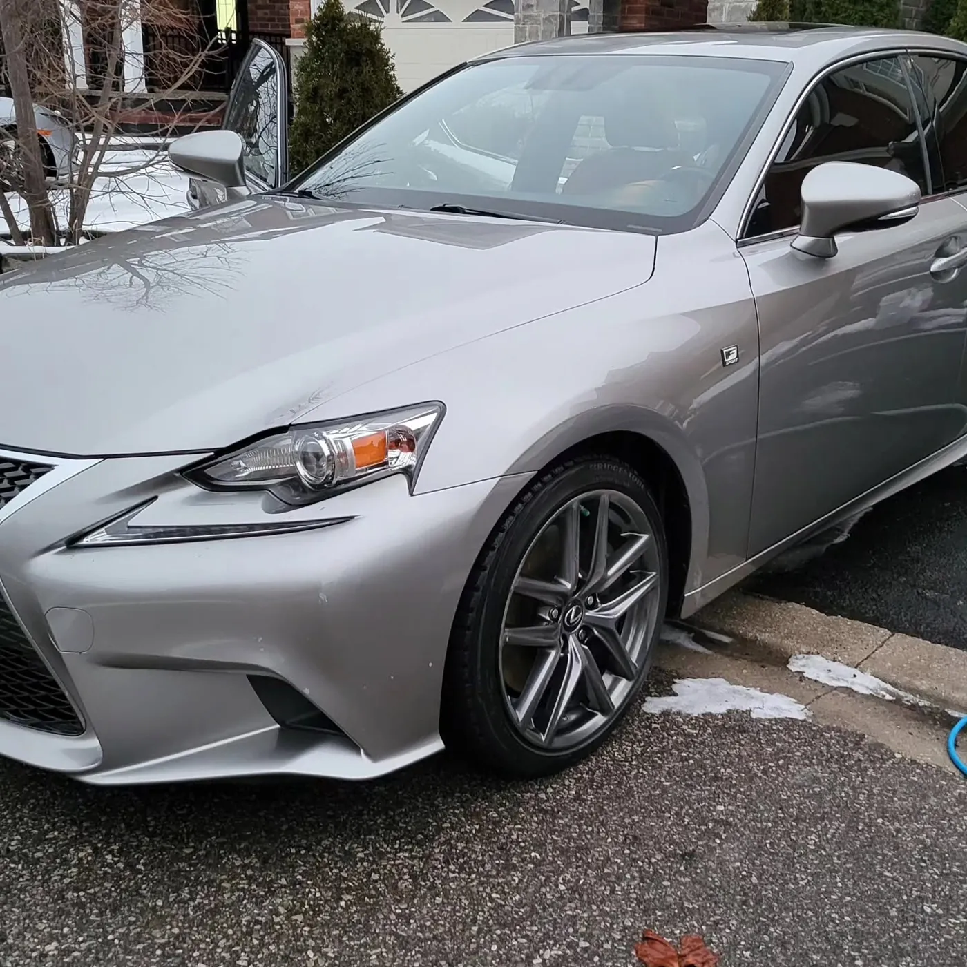 Silver Lexus IS after a winter exterior detail, snow on the ground